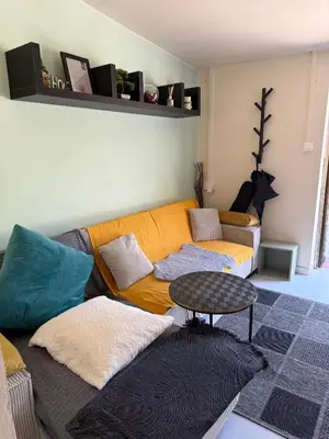 a living room with a couch and a table at Safari House with fireplace in Agros