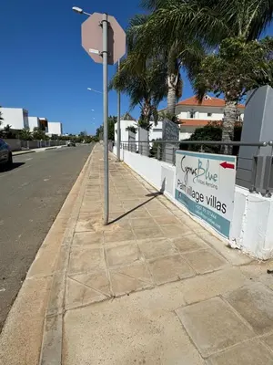 a pole on a sidewalk next to a street at Paez Villa in Protaras