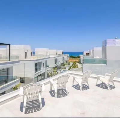 a group of chairs sitting on the roof of a building at By the beach Villa 2 in Protaras