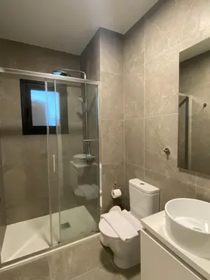 a bathroom with a shower and a toilet and a sink at Sunset Gardens - Holiday Apartments in Limassol