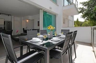 a dining room with a table and chairs at Alessia 2bed Apartment - Coralli Beachfront Resort in Protaras