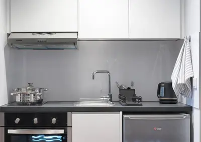 a kitchen with a stove top oven and a sink at Le Vert Suites Platres in Platres