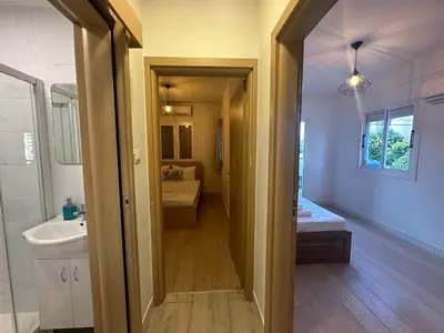 a bathroom with a sink and a toilet and a mirror at Appartments 750m from beach, tourist area in Limassol
