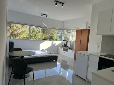 a kitchen with a table and a dining room at Appartments 750m from beach, tourist area in Limassol
