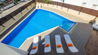 an overhead view of a swimming pool with lounge chairs at Protaras Holiday Villa 196 in Protaras