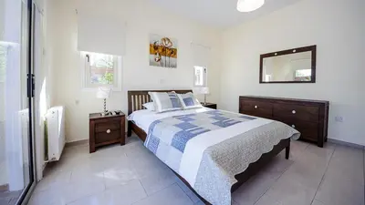 a bedroom with a bed and a mirror on the wall at Protaras Holiday Villa 196 in Protaras