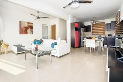 a living room with a couch and a table at Villa Thetida in Ayia Napa