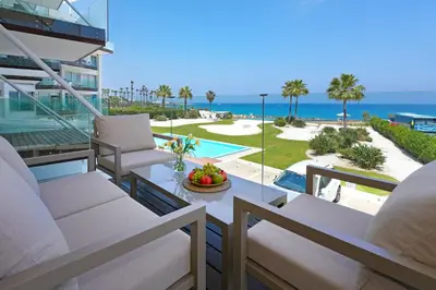 a balcony with chairs and a view of the ocean at Jenny - Beachfront Apartment in Protaras