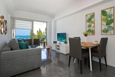 a living room with a couch and a table at Jenny - Beachfront Apartment in Protaras