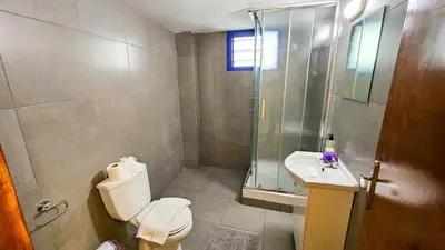 a bathroom with a shower and a toilet and a sink at Heaven City Apartment, 150m from Chabad Lubavitch in Larnaka