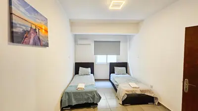 a room with two beds in a room at Heaven City Apartment, 150m from Chabad Lubavitch in Larnaka