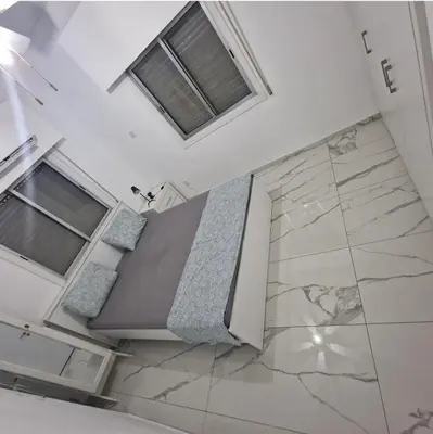 a room with a bed and two windows at Cozy 1 bedroom apartment Larnaca city-center F in Larnaka