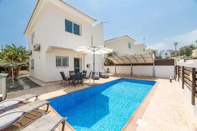 a villa with a swimming pool and a house at Villa Amesta in Protaras