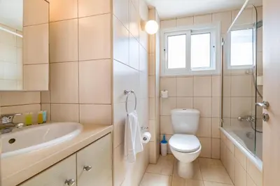 a bathroom with a toilet and a sink at Villa Amesta in Protaras