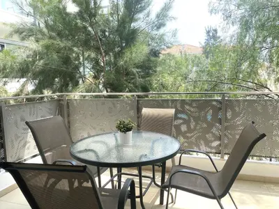 a table and chairs on a balcony with a window at DPSAE09 Mythical Sands Resort - Two Bedroom Apt with pool in Paralimni