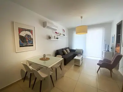 a living room with a couch and a table at DPSAE09 Mythical Sands Resort - Two Bedroom Apt with pool in Paralimni