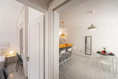 a kitchen and dining room with a table and chairs at Protaras O2 Seaside Suite in Protaras