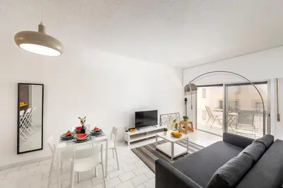 a living room with a couch and a table at Protaras O2 Seaside Suite in Protaras