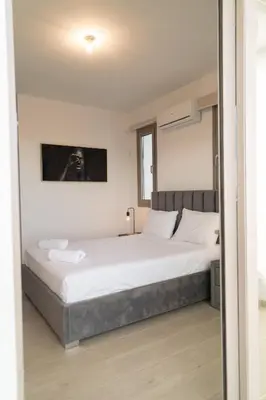 a bedroom with a large bed with white sheets at Hubstay - Seaview Villa Oriana in Larnaca in Larnaka