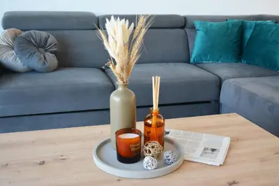 a coffee table with a vase and a vase with dried grass at Villa Aquamarine in Ayia Napa