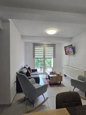 a living room with a couch and a table at Maryland River Liz in Kakopetria