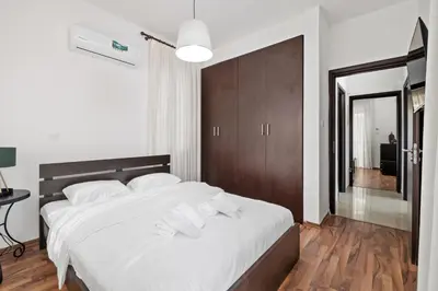 a bedroom with a large white bed with white pillows at Villa with private pool in Pervolia, Larnaca in Pervolia