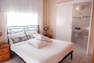 a bedroom with a bed with a shower and a sink at Mermaid Villa 16 in Ayia Napa