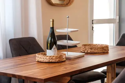 a bottle of wine sitting on top of a wooden table at Mermaid Villa 16 in Ayia Napa
