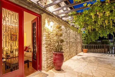 a patio with a brick wall and a red door at No 1 Mandria in Limassol