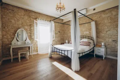 a bedroom with a canopy bed and a mirror at No 1 Mandria in Limassol