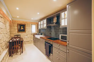 a kitchen with gray cabinets and a counter top at No 1 Mandria in Limassol