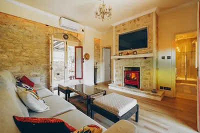 a living room with a couch and a fireplace at No 1 Mandria in Limassol