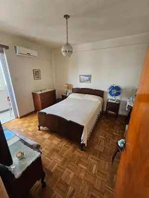 a bedroom with a large bed and a wooden floor at Beautiful Apartment in Center of Nicosia with views in Nicosia