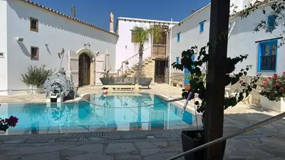 a swimming pool in the middle of a house at Little Stone House in Lymbia