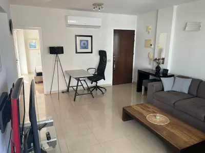 a living room with a couch and a table at Superb Seaview Flat, Prime Area in Larnaka