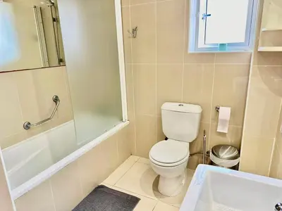 a bathroom with a toilet and a shower and a sink at Superb Seaview Flat, Prime Area in Larnaka