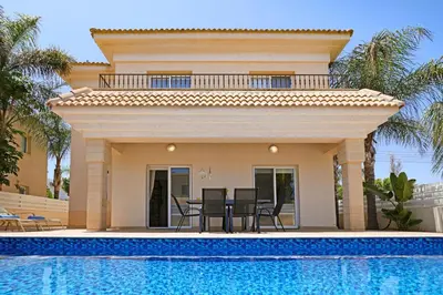 a villa with a swimming pool and a house at Villa Angelina - 300m from Kapparis beach in Paralimni