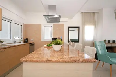 a kitchen with a large island with a counter top at Villa Angelina - 300m from Kapparis beach in Paralimni