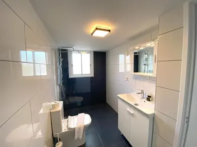 a white bathroom with a toilet and a sink at Cozy 1 BDR in Nicosia city center - Aiantos By Platform 357 in Strovolos