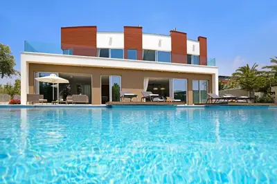 a house with a swimming pool in front of it at Royal Oasis Villa in Ayia Napa