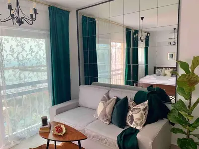 a living room with a couch and a mirror at Aria Sea View Studio in Larnaka
