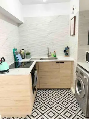 a kitchen with a sink and a washing machine at Emma Sea View Suite in Larnaka
