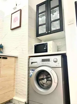 a washing machine in a kitchen with a cabinet at Emma Sea View Suite in Larnaka