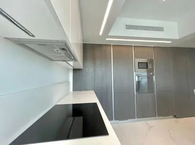 a kitchen with a stainless steel refrigerator and a microwave at Penthouse Luxury Apartment in Nicosia
