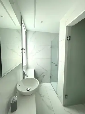 a white bathroom with a sink and a shower at Penthouse Luxury Apartment in Nicosia