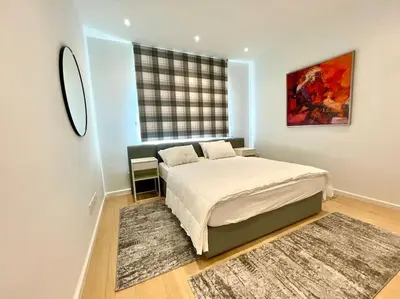 a bedroom with a large bed and a window at Penthouse Luxury Apartment in Nicosia