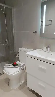 a bathroom with a toilet and a shower and a sink at Larvella Estia Luxury Suites in Larnaka