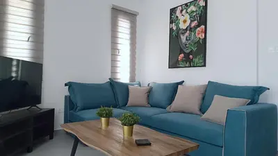 a living room with a blue couch and a coffee table at Larvella Estia Luxury Suites in Larnaka