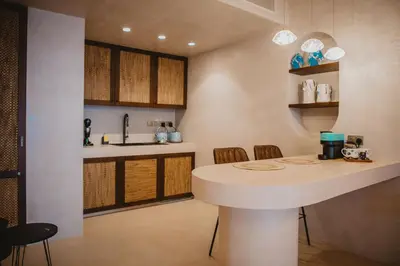 a kitchen with a white island in a room at Q Coconuts Seaside Suites in Limassol