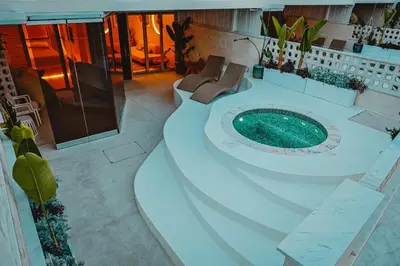 a large bathroom with a pool in the middle of it at Q Coconuts Seaside Suites in Limassol